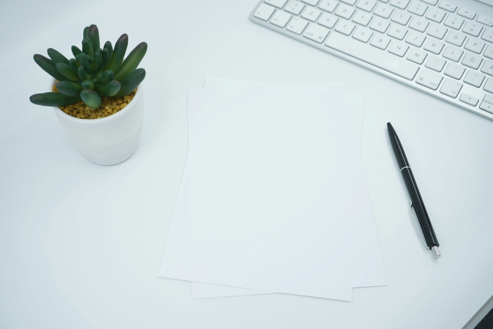 Neutral, simple desk with a product box and notebook